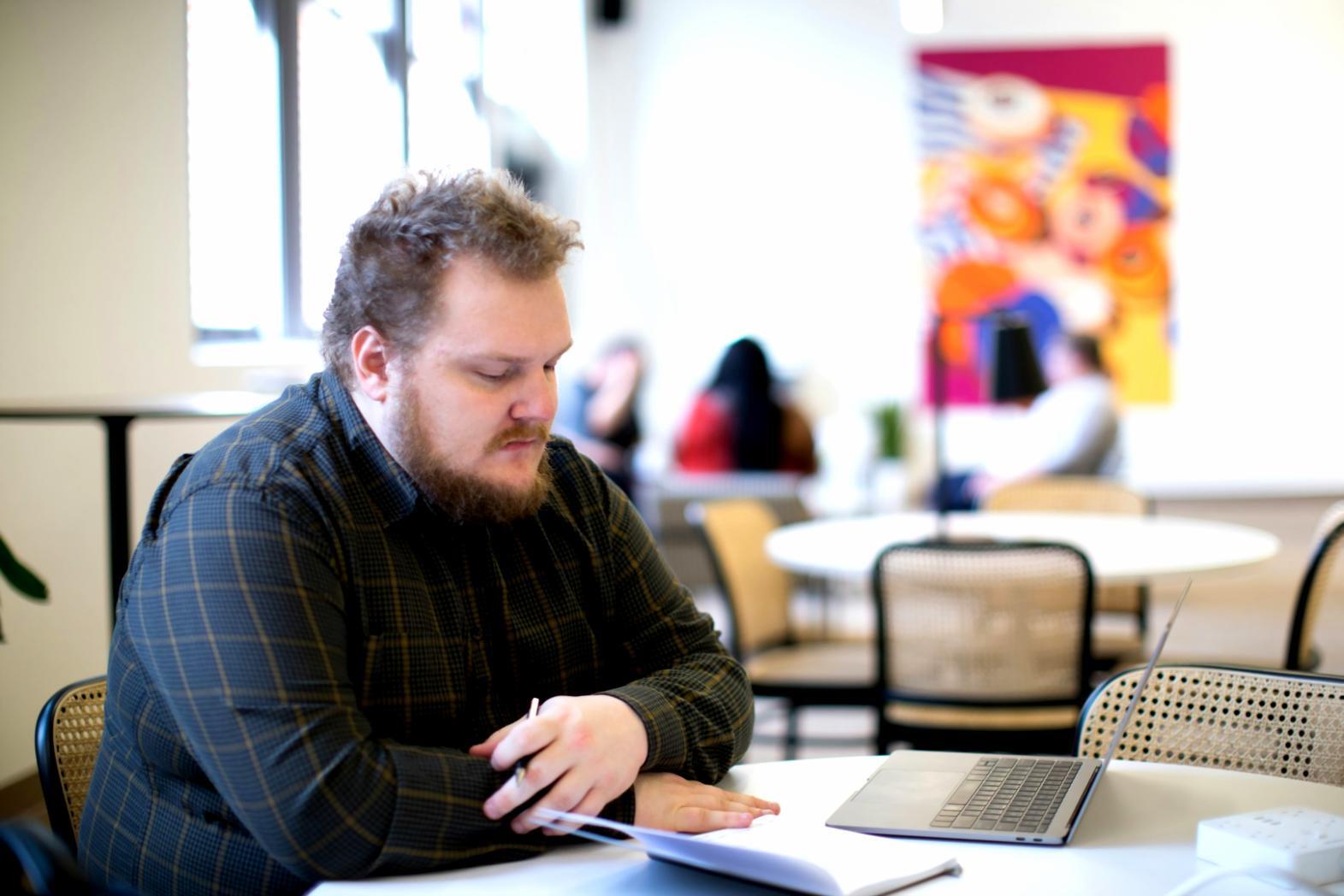 Person reviewing financial categorization worksheets and documentation